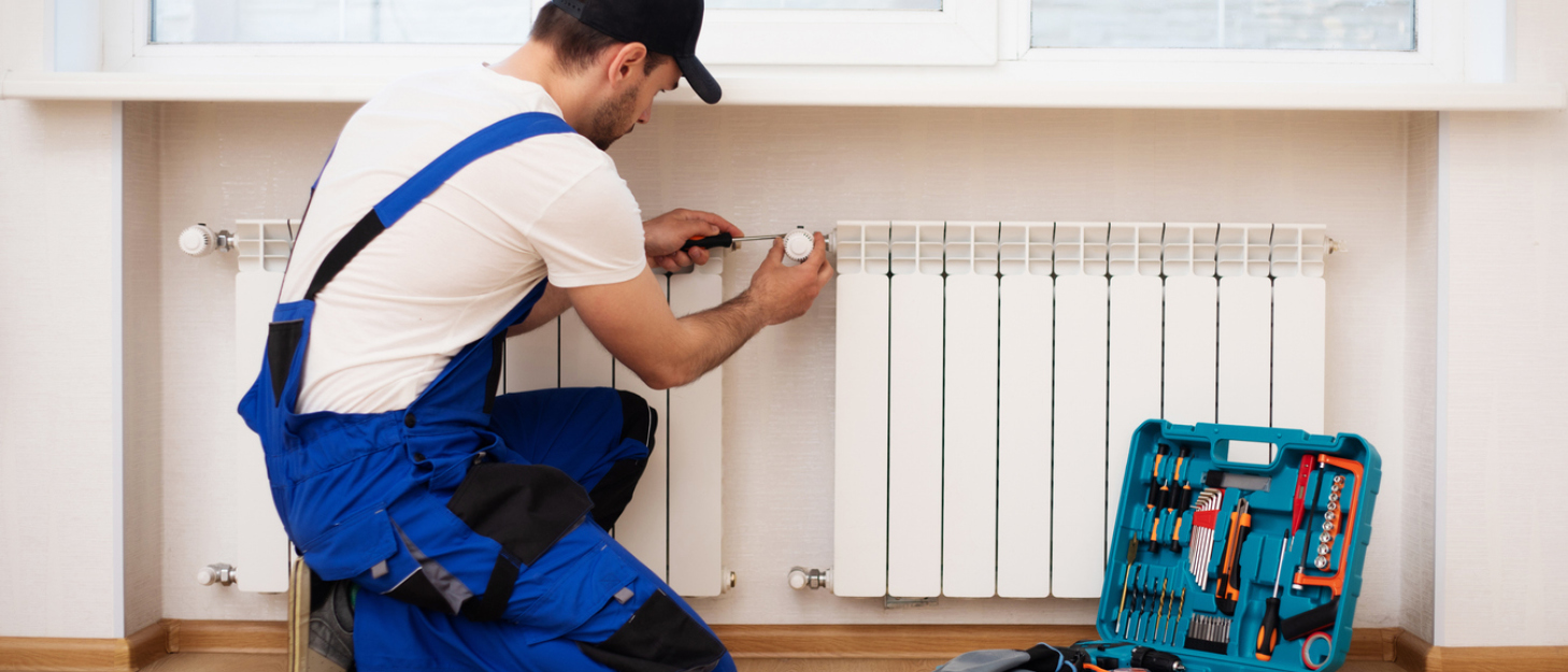 Tradesman installing gas heating